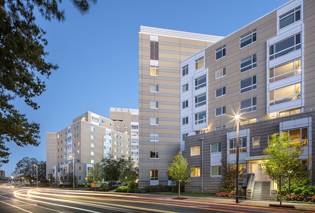 a city street with a row of apartment buildings